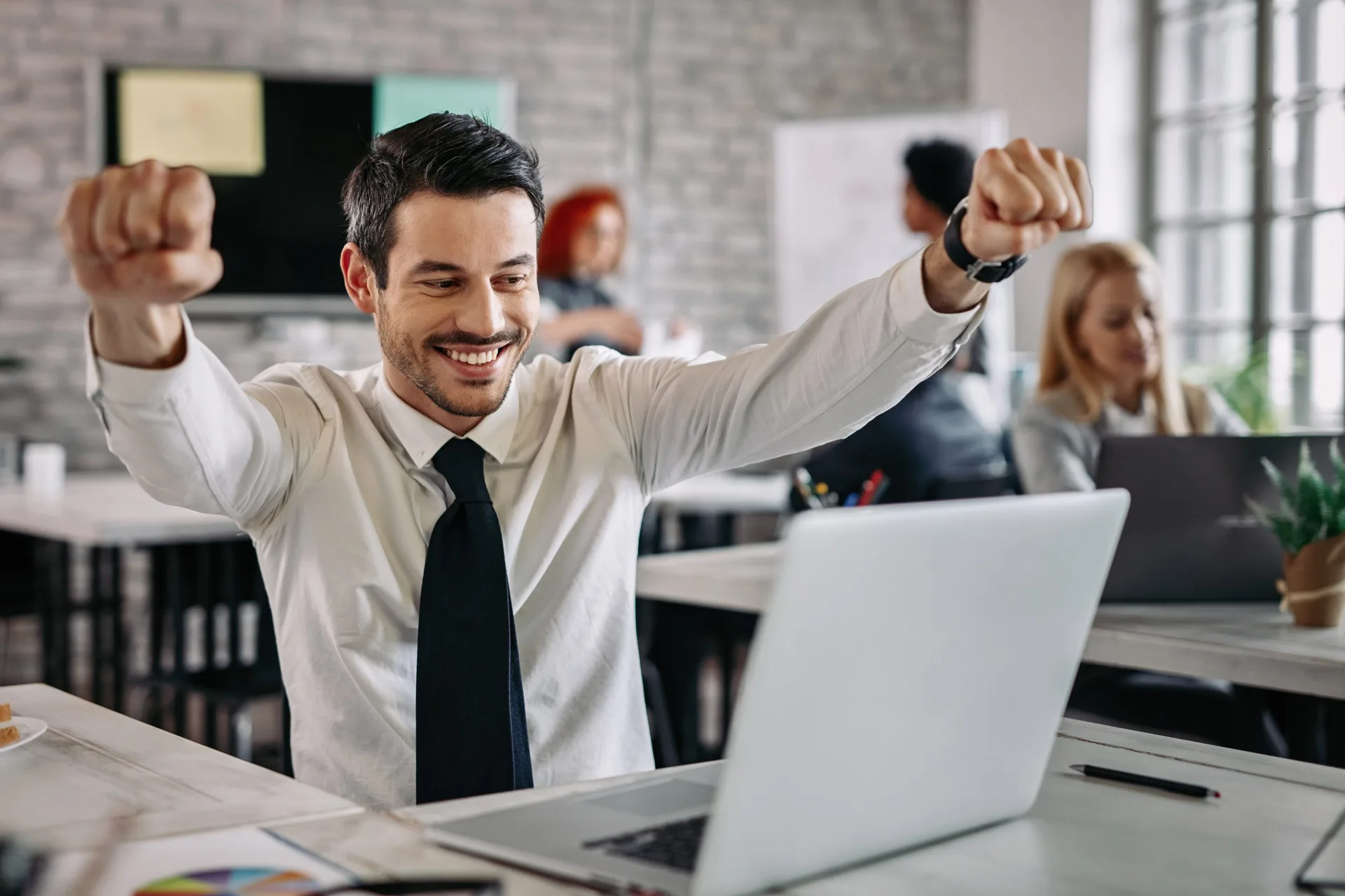 A businessman celebrating success in an office